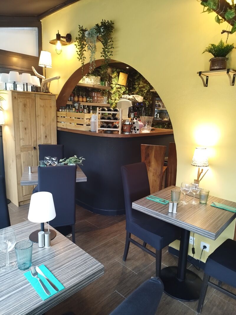 Salle voûtée bohème : mur curry, bar bleu nuit et mur végétal